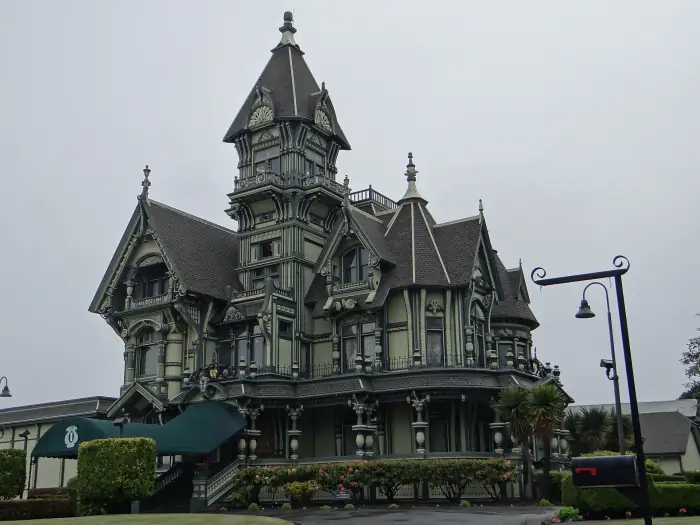 The Carson Mansion in Eureka, an ornate three-story Victorian with a corner tower, iron cresting and manicured hedges