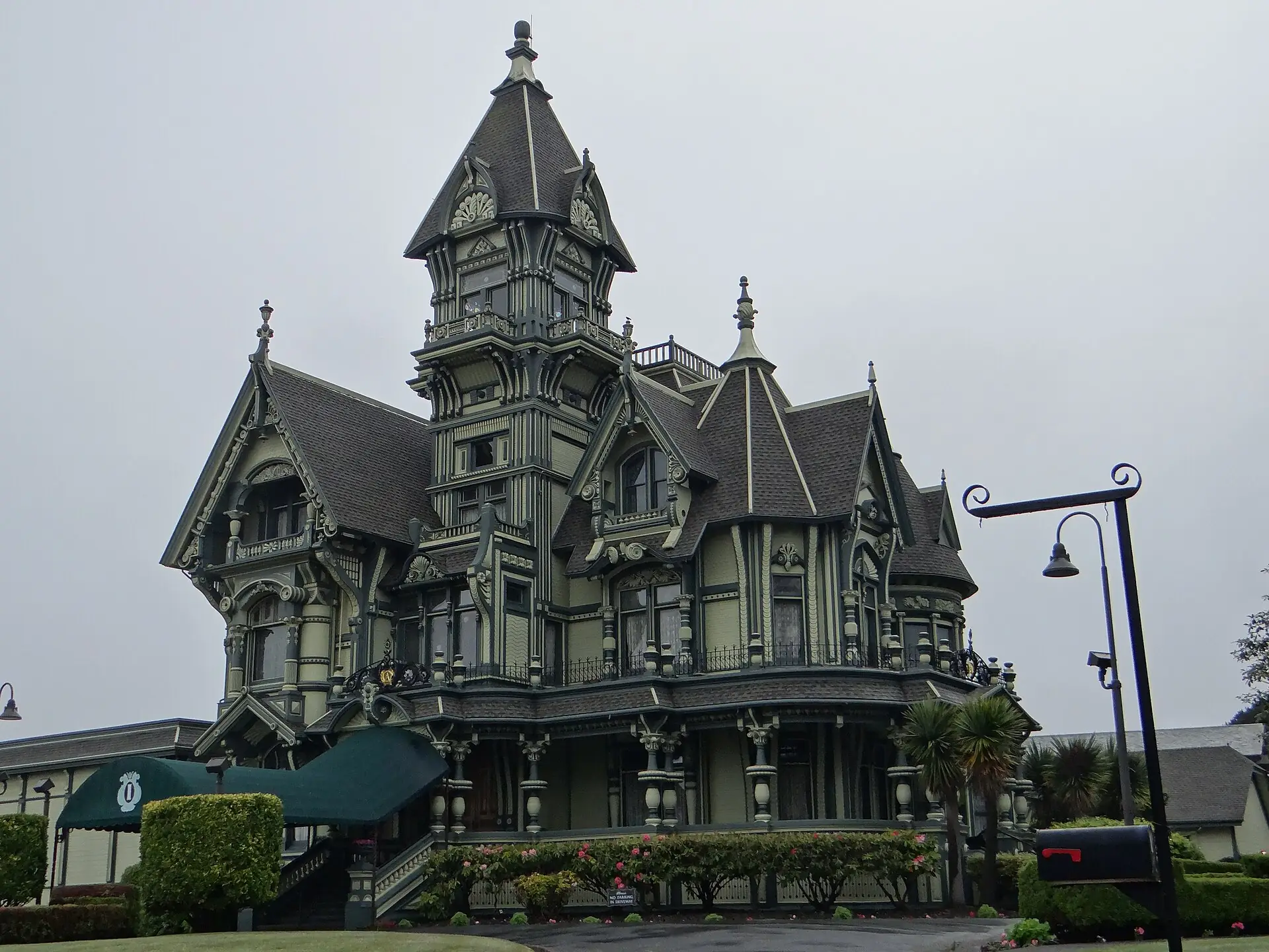 The Carson Mansion in Eureka, an ornate three-story Victorian with a corner tower, iron cresting and manicured hedges