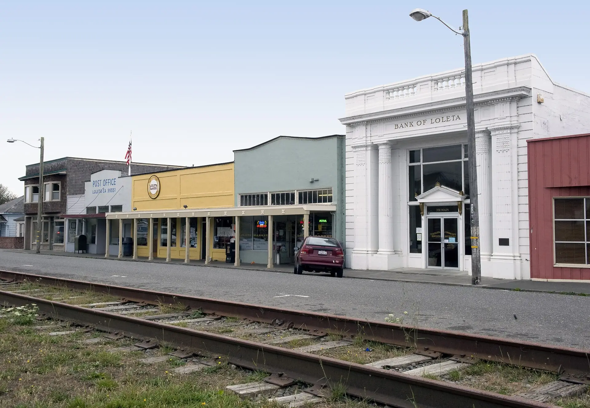 Loleta's small Main Street across the old rail tracks: the post office, the bakery and the columned Bank of Loleta building